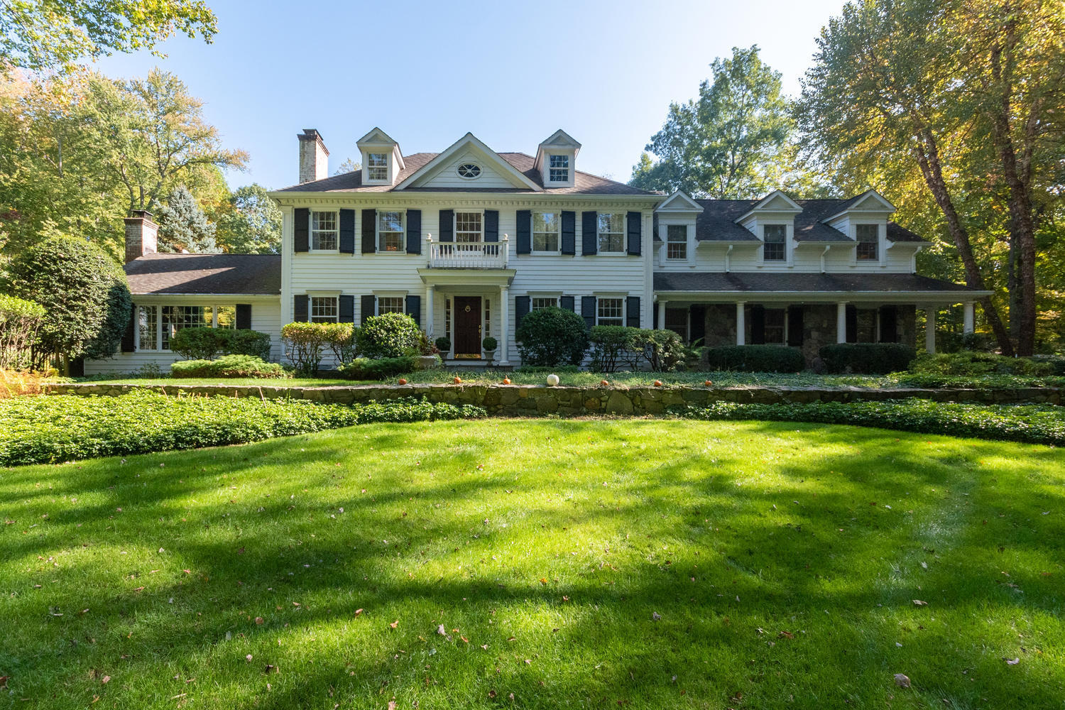 16 Shagbark Road Darien, CT 06820 - Photo 1 of 55 a front view of a house with a yard table and chairs