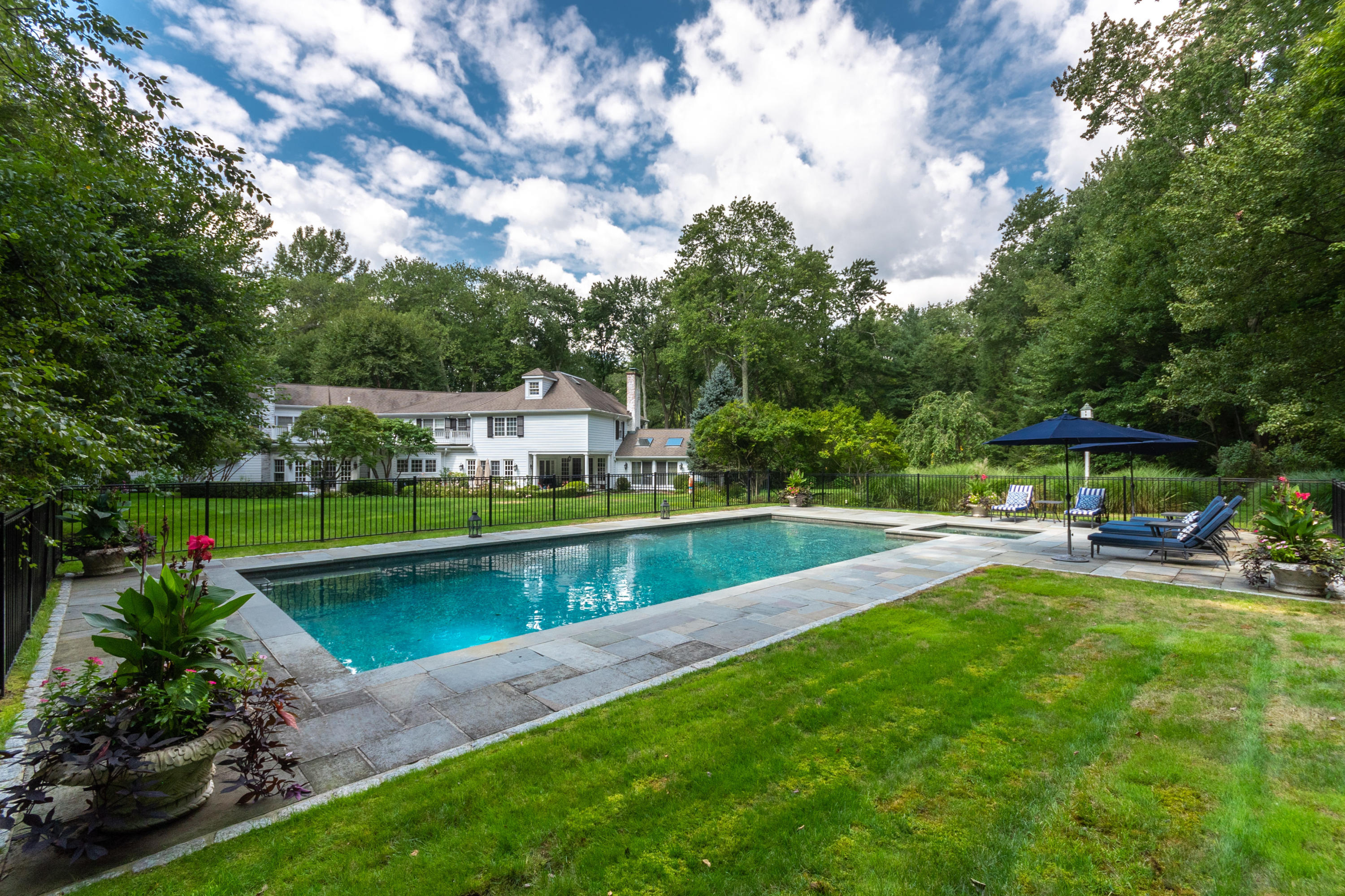 16 Shagbark Road Darien, CT 06820 - Photo 2 of 55 a view of a house with swimming pool and sitting area