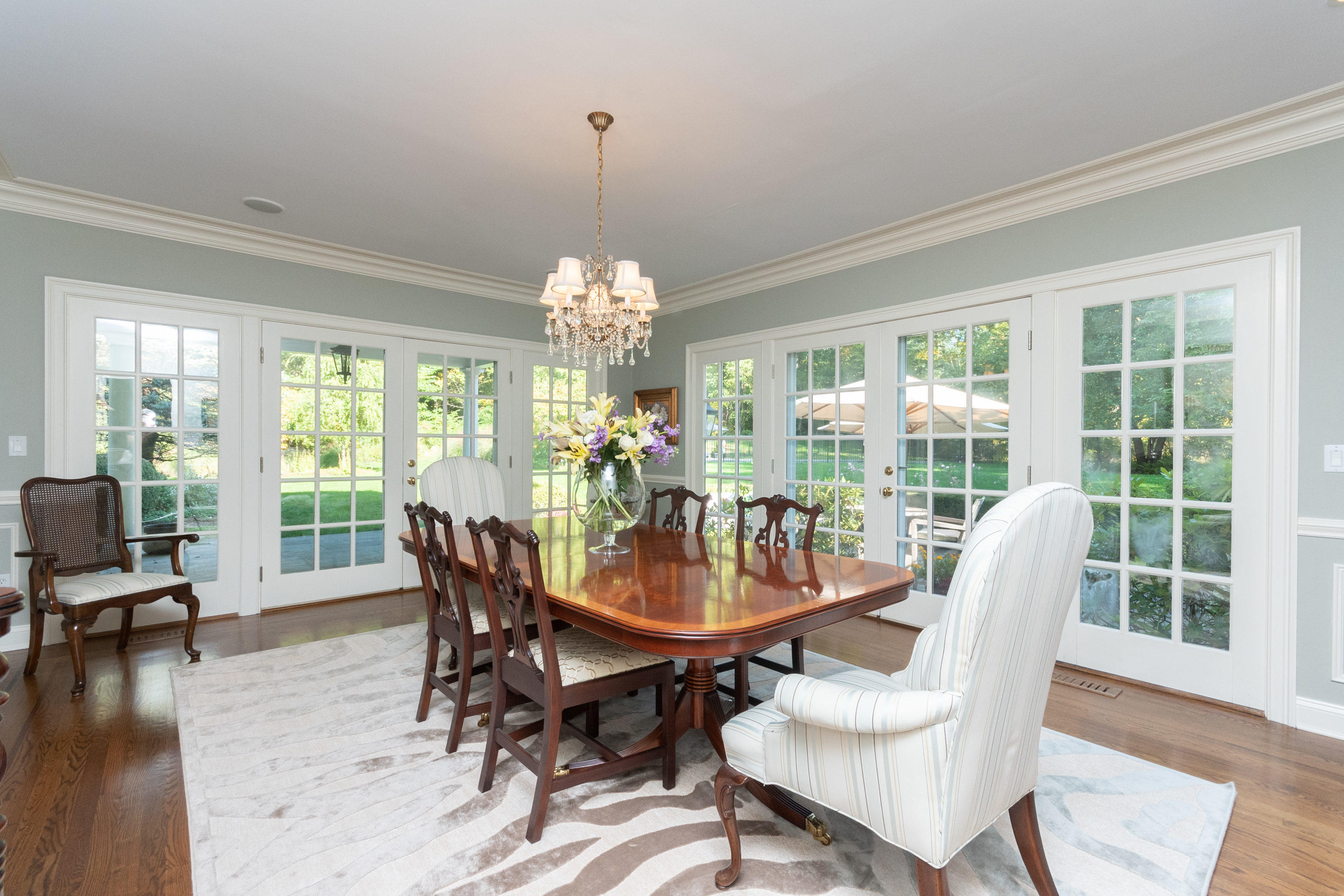 16 Shagbark Road Darien, CT 06820 - Photo 13 of 55 a dining room with furniture a chandelier and wooden floor
