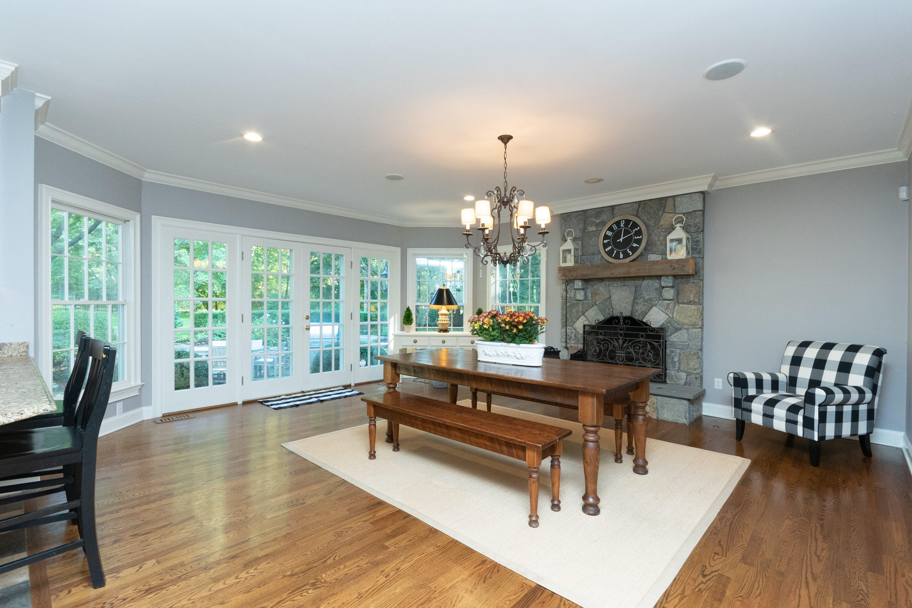 16 Shagbark Road Darien, CT 06820 - Photo 18 of 55 a living room with furniture dining table a fireplace and a large window