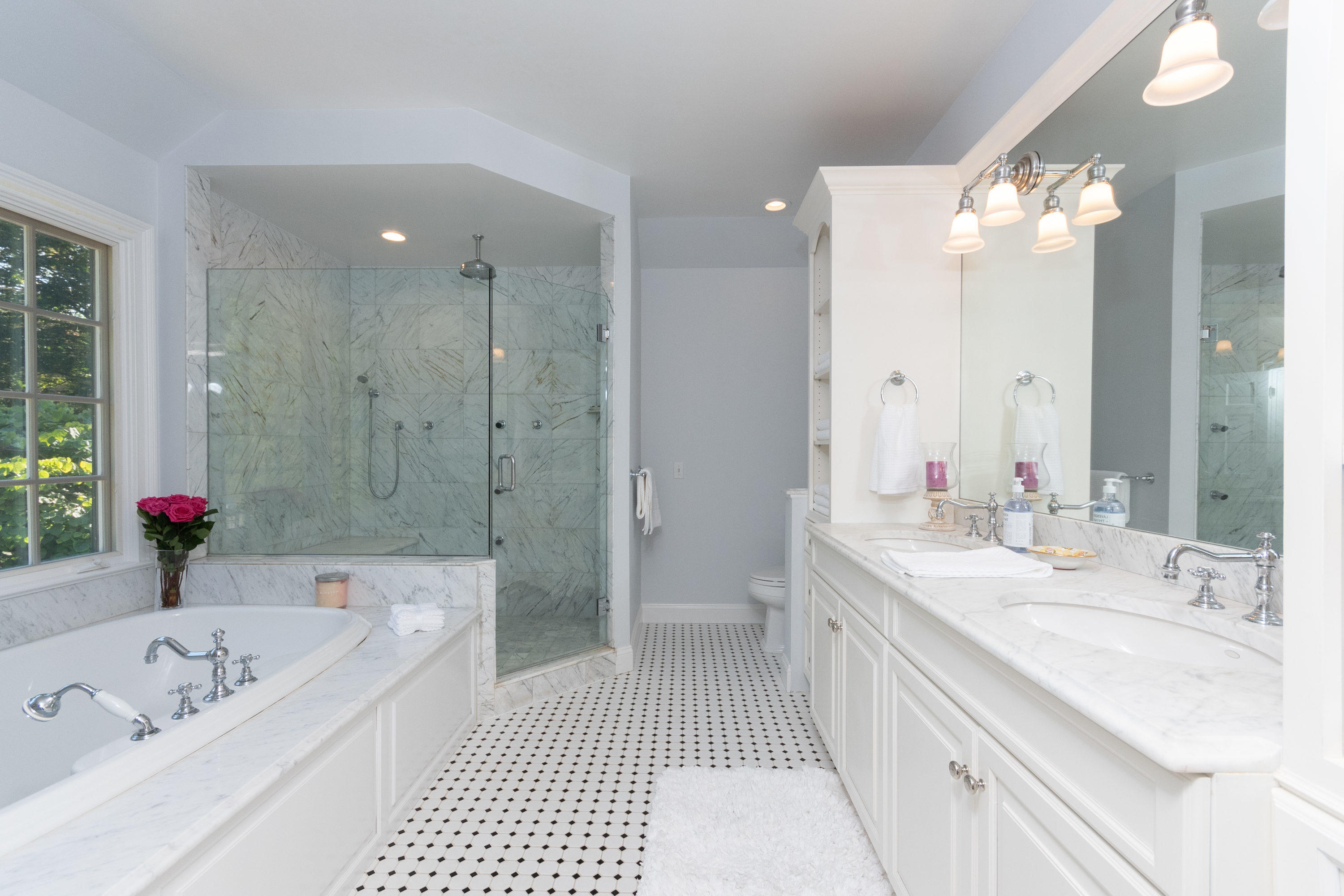 16 Shagbark Road Darien, CT 06820 - Photo 28 of 55 a bathroom with a tub a sink shower and a mirror