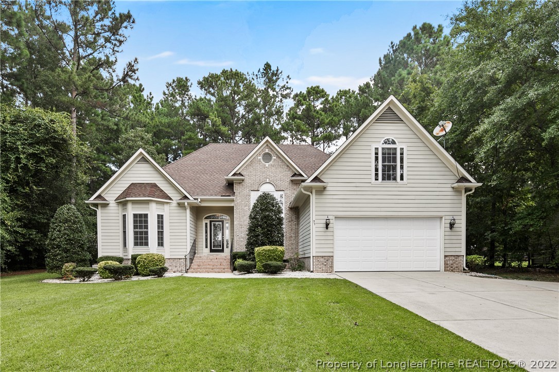 95 Crystal Point Sanford, NC 27332 - Photo 1 of 33 a view of a yard in front of a house with plants and large tree
