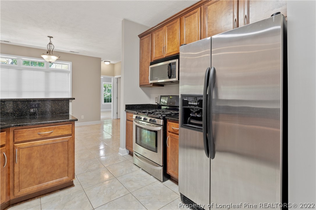 95 Crystal Point Sanford, NC 27332 - Photo 12 of 33 a kitchen with stainless steel appliances granite countertop a refrigerator a stove and a sink