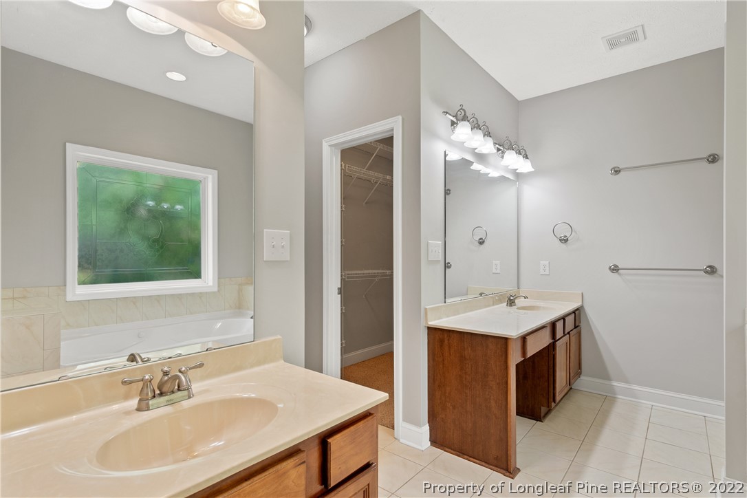 95 Crystal Point Sanford, NC 27332 - Photo 17 of 33 a en suite bathroom with a double vanity sink a mirror and a shower