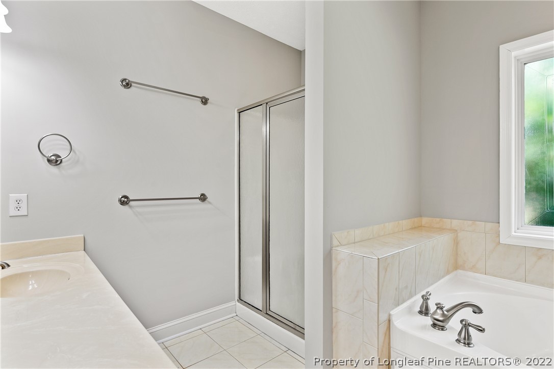 95 Crystal Point Sanford, NC 27332 - Photo 18 of 33 a bathroom with a bathtub and a window