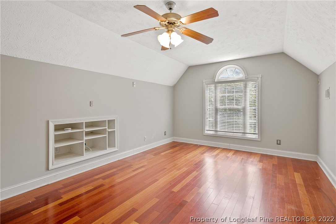 95 Crystal Point Sanford, NC 27332 - Photo 29 of 33 an empty room with wooden floor chandelier fan and windows
