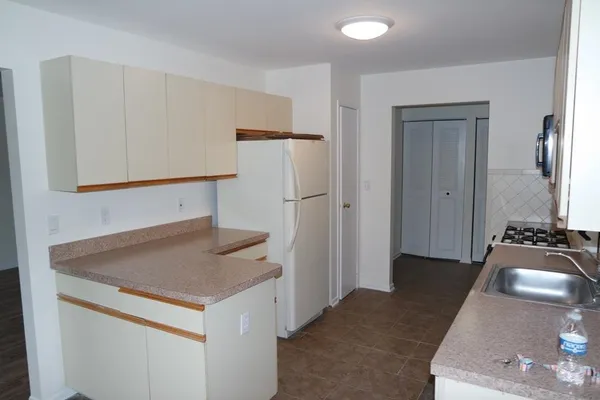 a kitchen with a sink and refrigerator