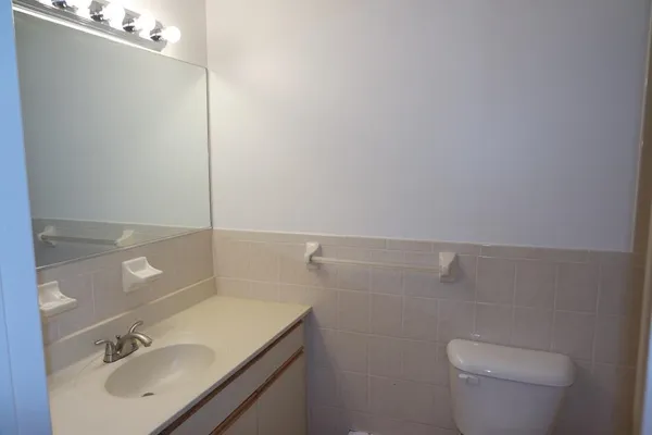 a bathroom with a sink toilet and vanity