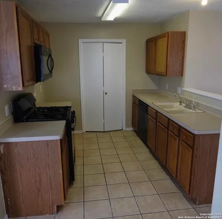 a kitchen with a sink and a stove top oven