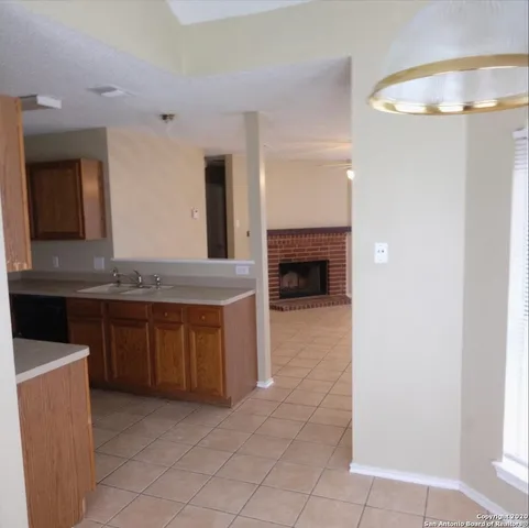 a spacious bathroom with a granite countertop sink and a mirror