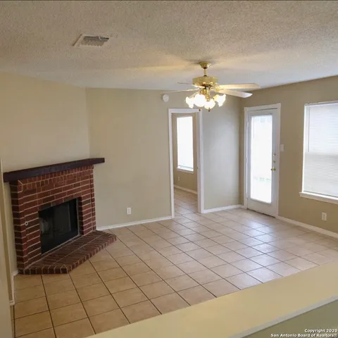 a view of a livingroom with an empty space and a window