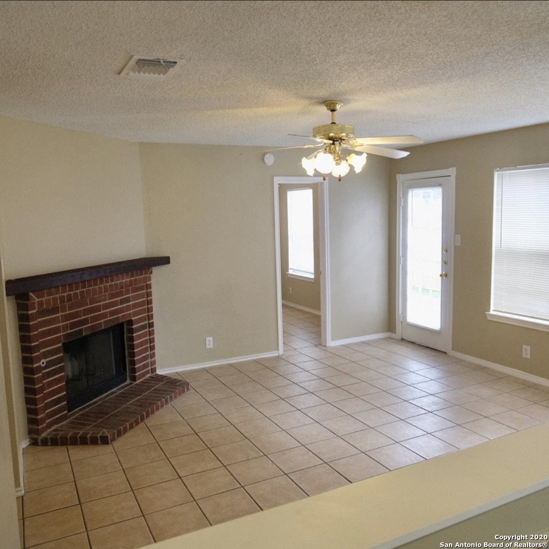 9818 Autumn Valley Converse, TX 78109 - Photo 8 of 21 an empty room with windows and fireplace