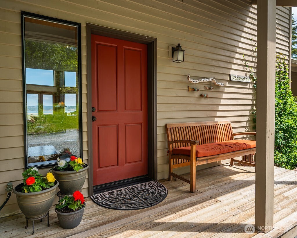 3757 Mud Bay Road Lopez Island, WA 98261 - Photo 6 of 40 a view of a porch with a chair and potted plant