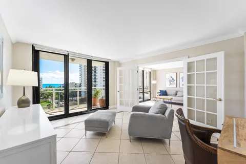 a living room with furniture and large windows