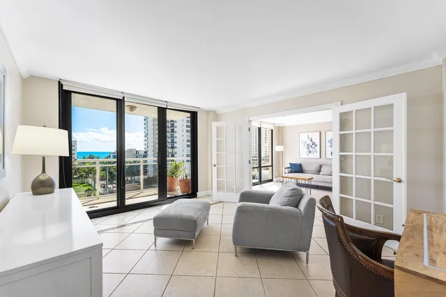 a living room with furniture and large windows
