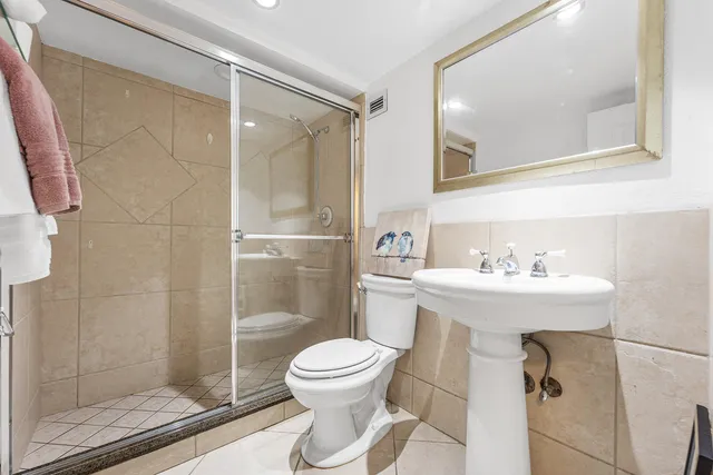 a bathroom with a sink toilet and shower