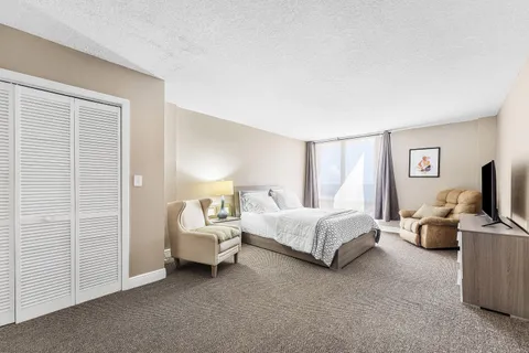 a spacious bedroom with a bed and a couch