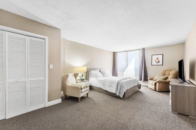 a spacious bedroom with a bed and a couch