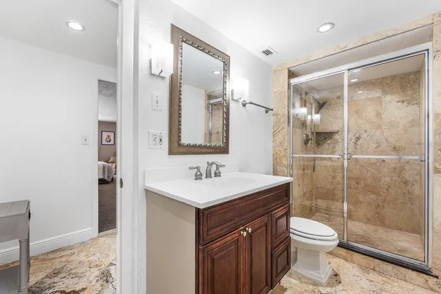 a bathroom with a sink toilet and shower