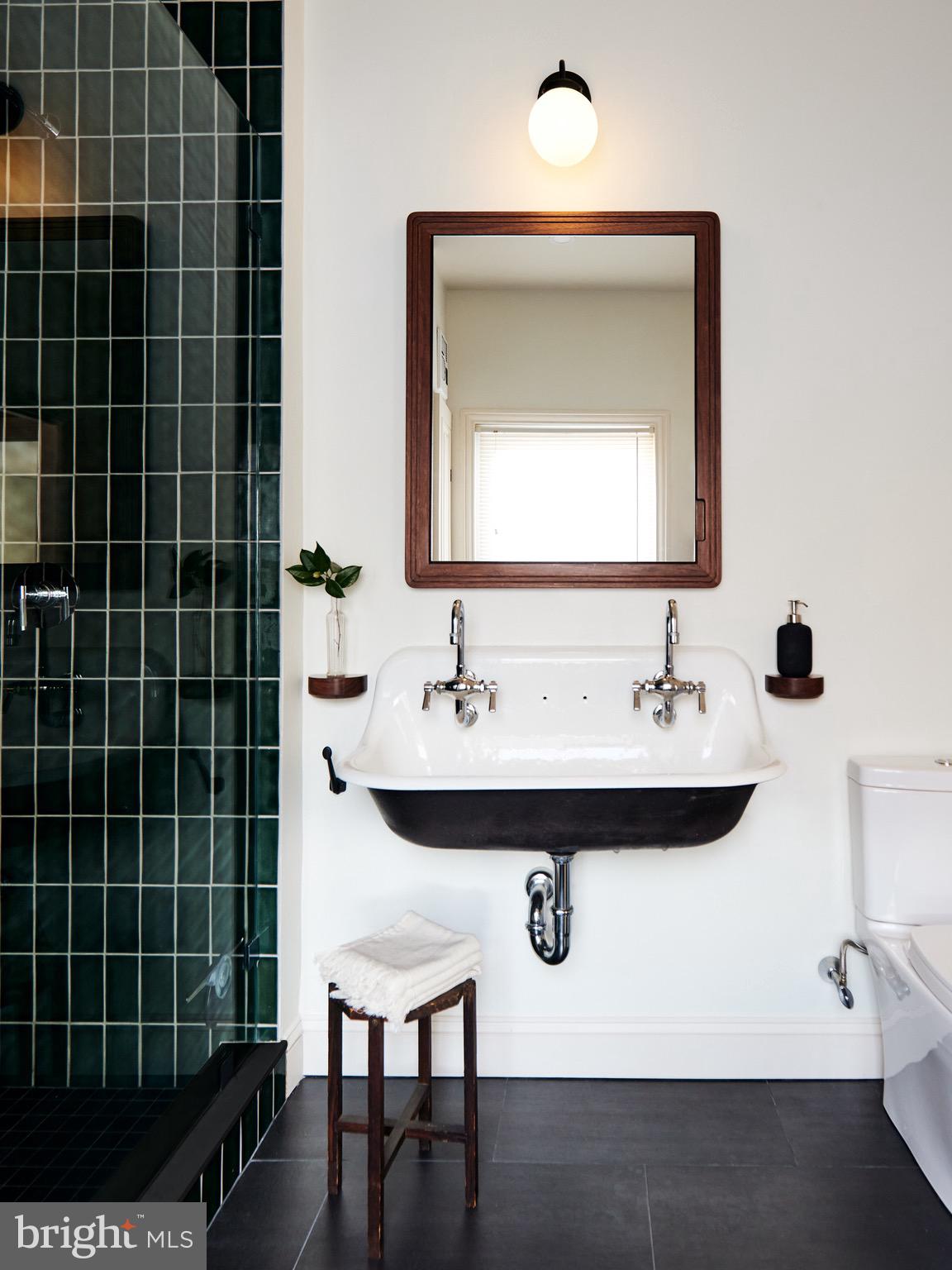 978 North 5th Street Philadelphia, PA 19123 - Photo 23 of 36 a bathroom with a sink a mirror and a shower