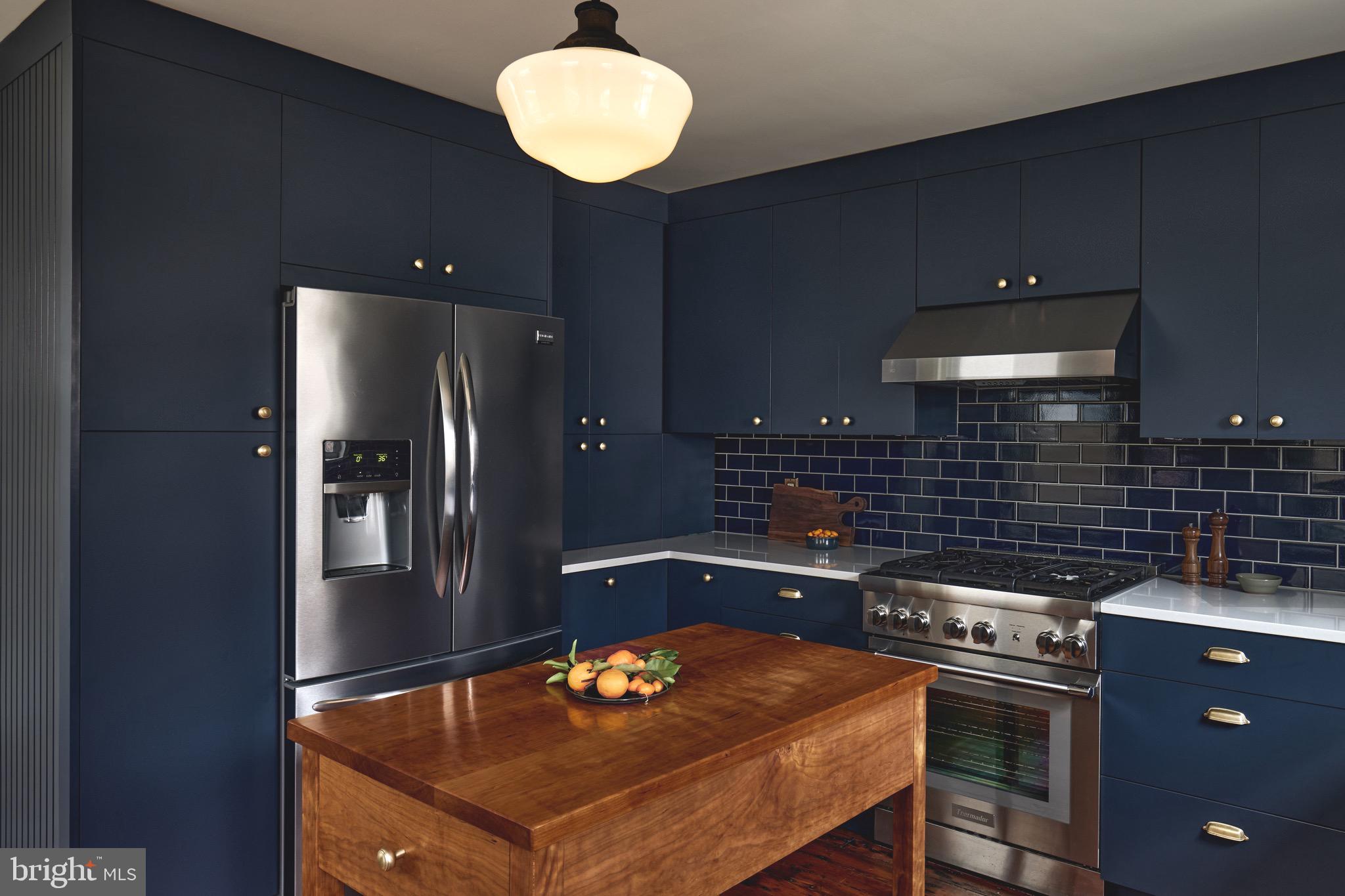978 North 5th Street Philadelphia, PA 19123 - Photo 4 of 36 a kitchen with a stove and a refrigerator