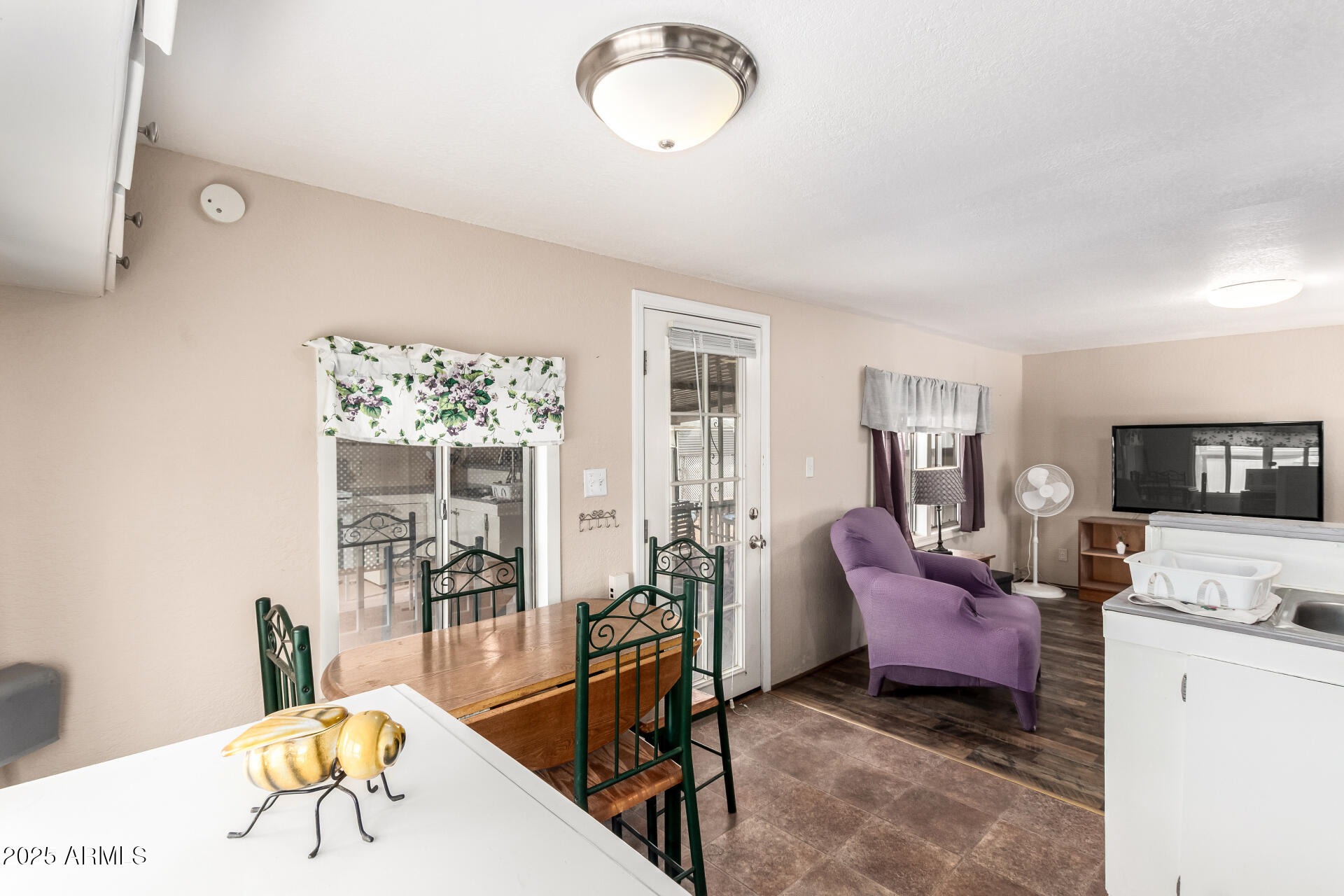 800 West Apache Trail, Unit 24 Apache Junction, AZ 85120 - Photo 13 of 27 a living room with furniture a flat screen tv and a table