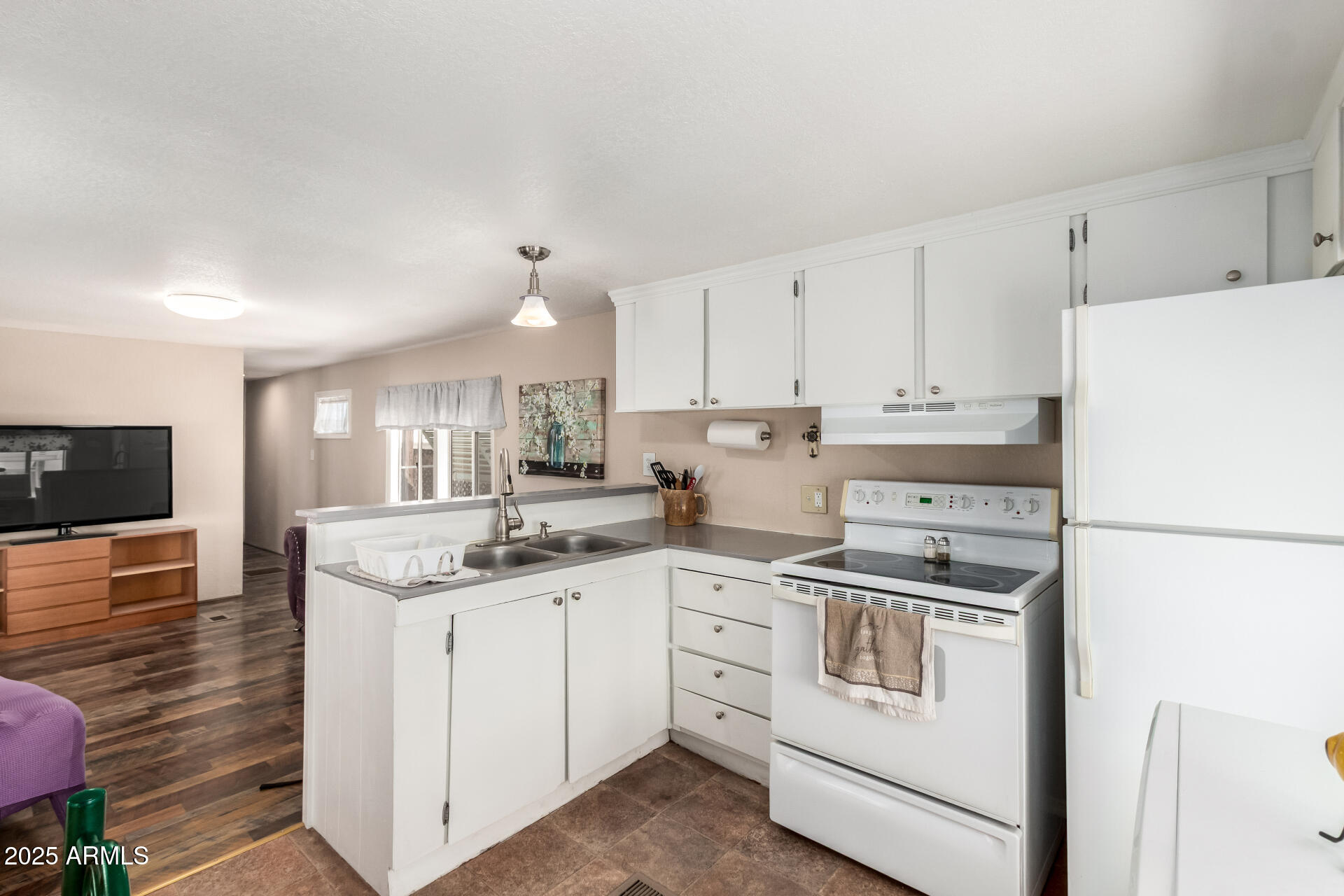800 West Apache Trail, Unit 24 Apache Junction, AZ 85120 - Photo 14 of 27 a kitchen with white cabinets sink and white appliances