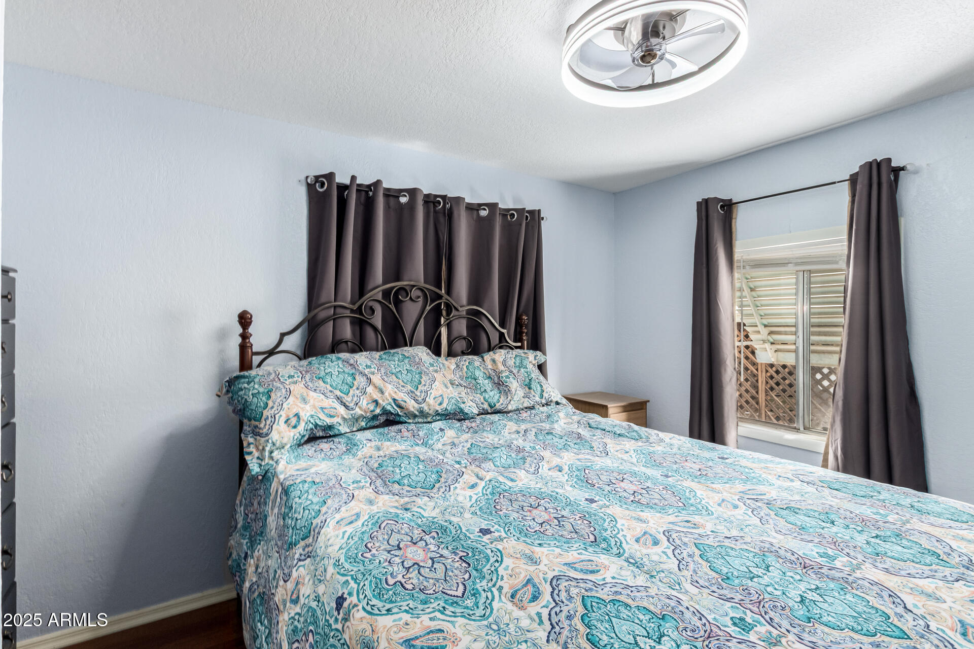 800 West Apache Trail, Unit 24 Apache Junction, AZ 85120 - Photo 17 of 27 a bedroom with a bed and a chandelier