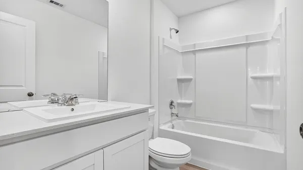 an empty room with a window and mirror