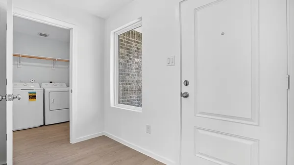 a view of a house with backyard and wooden fence