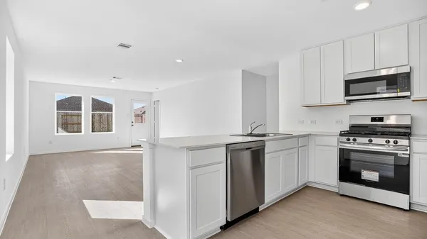 a kitchen with stainless steel appliances granite countertop a stove and a sink