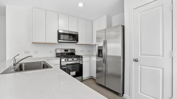 a kitchen with a refrigerator stove and microwave