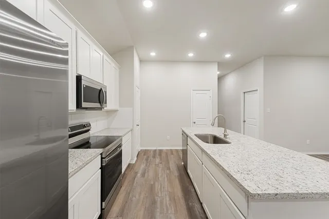a kitchen with a sink stove and microwave