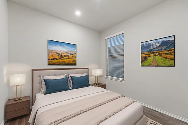 a bedroom with a bed and painting on the wall