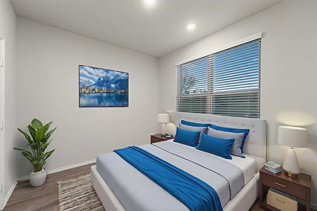 a bedroom with bed and a potted plant