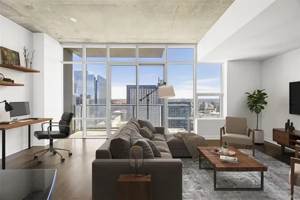 a living room with furniture and a floor to ceiling window