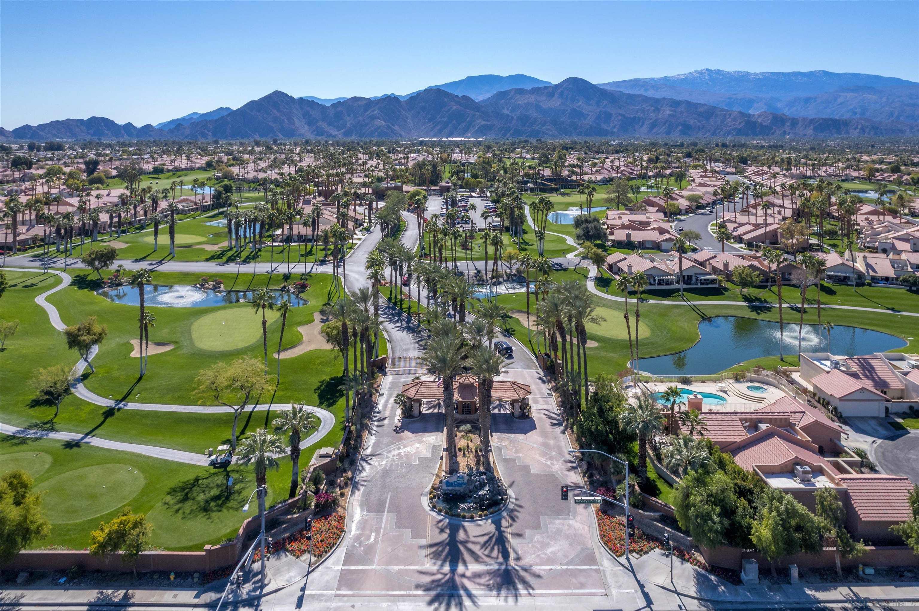 76923 Turendot Street Palm Desert, CA 92211 - Photo 1 of 36 an aerial view of a house with a garden and lake view