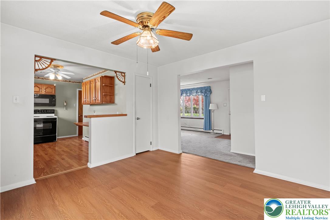 2141 Aster Road Lower Macungie Township, PA 18062 - Photo 30 of 62 a view of a kitchen with wooden floor and a ceiling fan