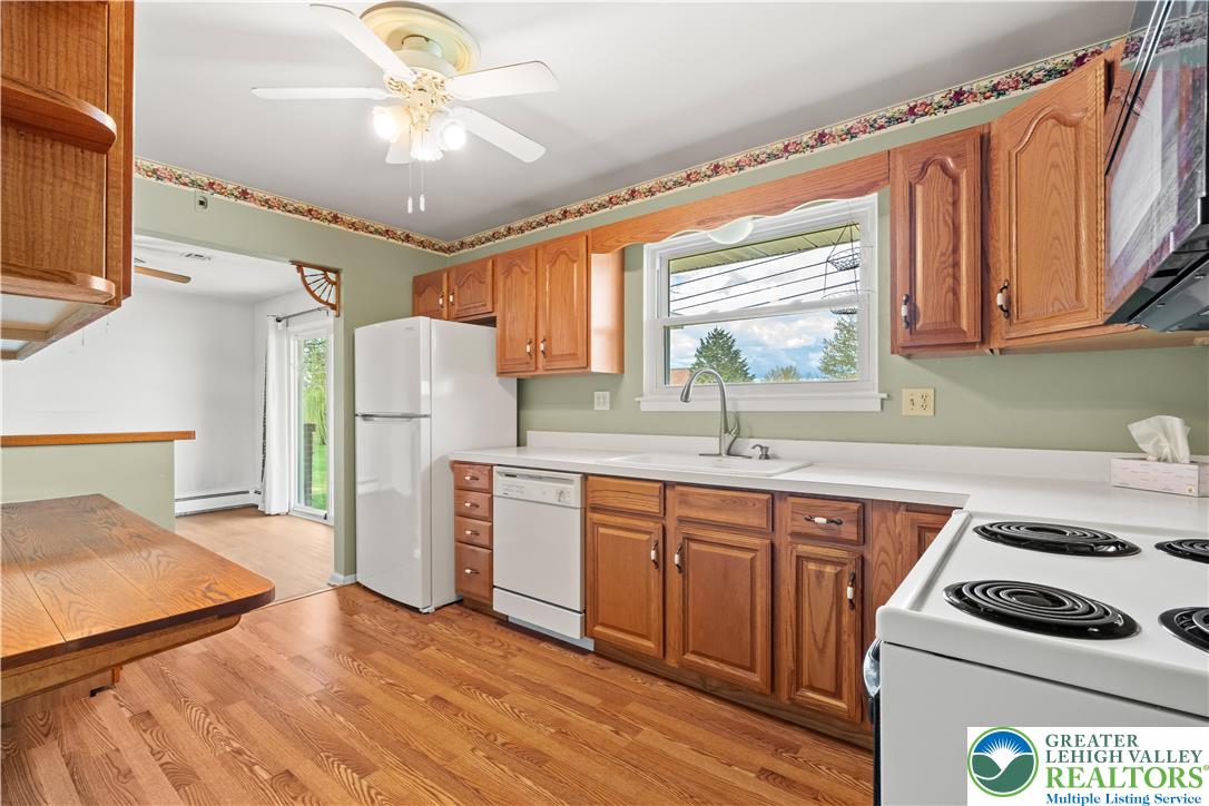 2141 Aster Road Lower Macungie Township, PA 18062 - Photo 34 of 62 a kitchen with a refrigerator a sink and cabinets