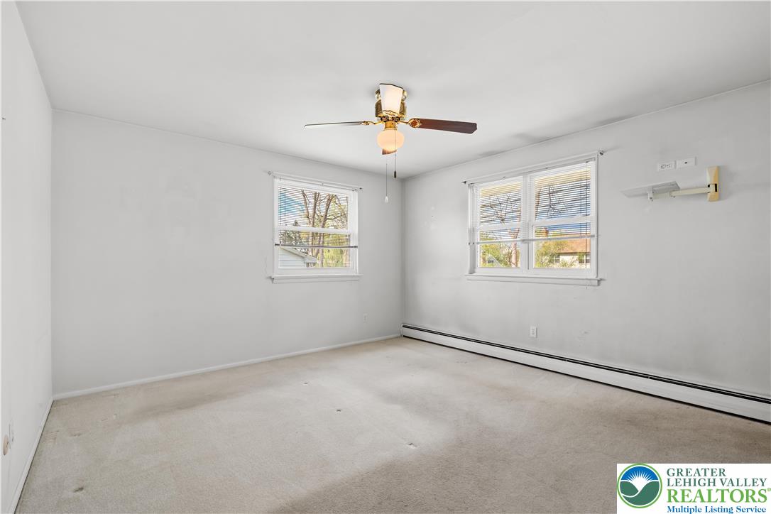 2141 Aster Road Lower Macungie Township, PA 18062 - Photo 38 of 62 an empty room with windows and fan