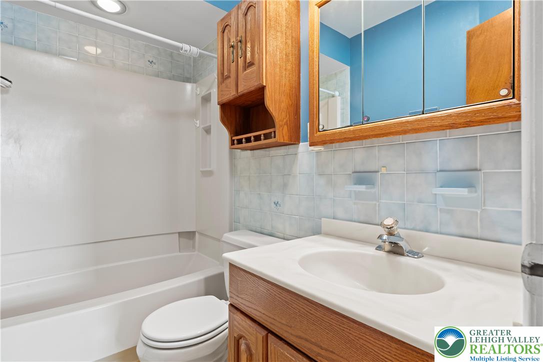 2141 Aster Road Lower Macungie Township, PA 18062 - Photo 49 of 62 a bathroom with a sink a toilet and bathtub
