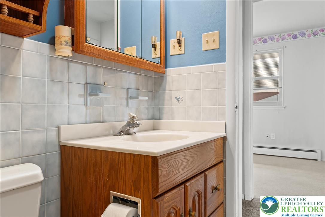 2141 Aster Road Lower Macungie Township, PA 18062 - Photo 50 of 62 a bathroom with a sink and mirror