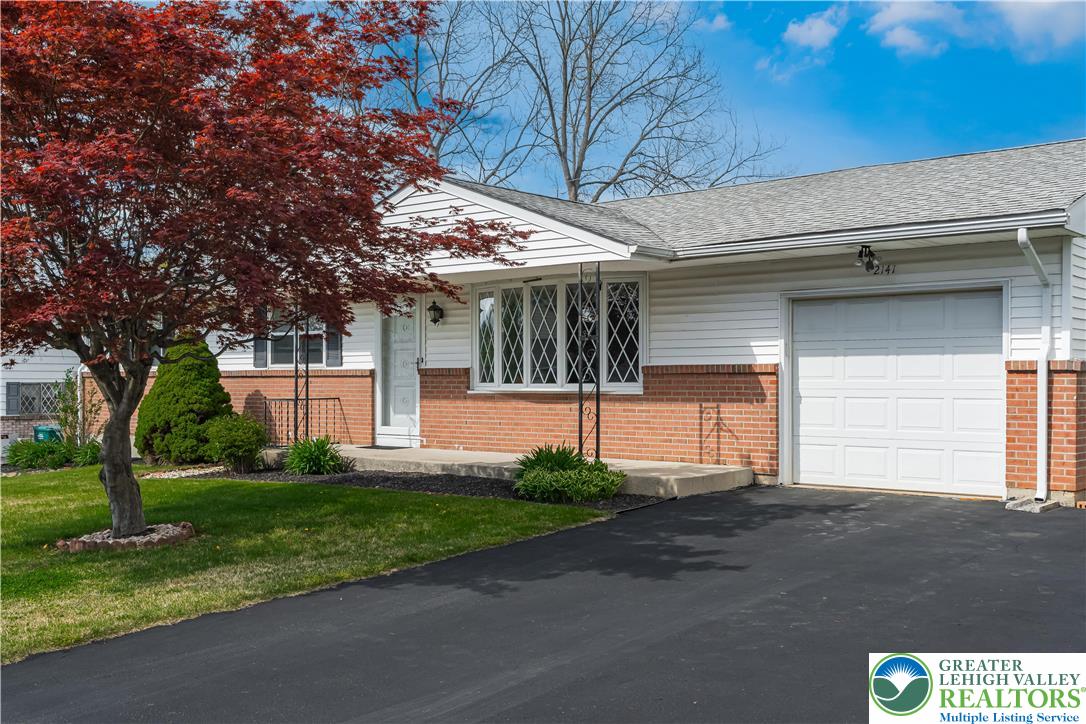 2141 Aster Road Lower Macungie Township, PA 18062 - Photo 5 of 62 a front view of a house with a yard and garage