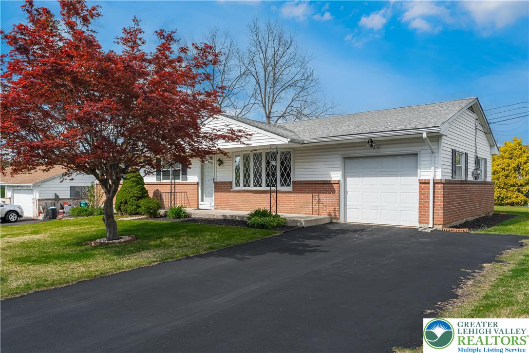2141 Aster Road Lower Macungie Township, PA 18062 - Photo 8 of 62 a front view of a house with a yard and garage