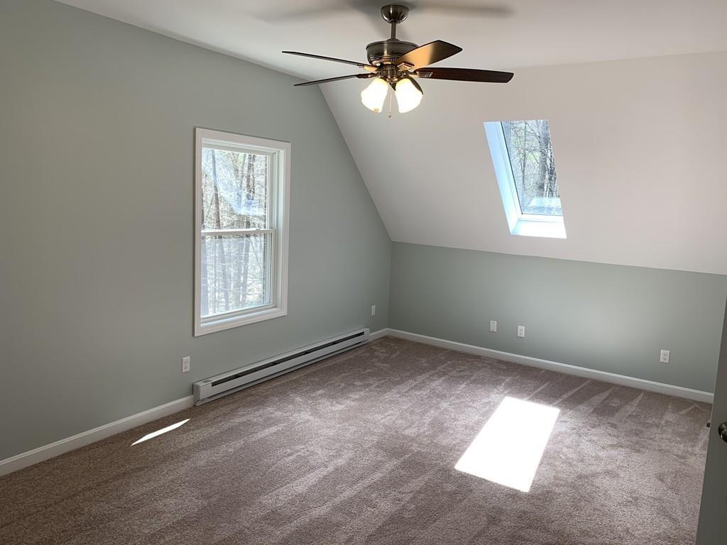 77 May Brook Road Holland, MA 01521 - Photo 13 of 23 an empty room with windows and fan