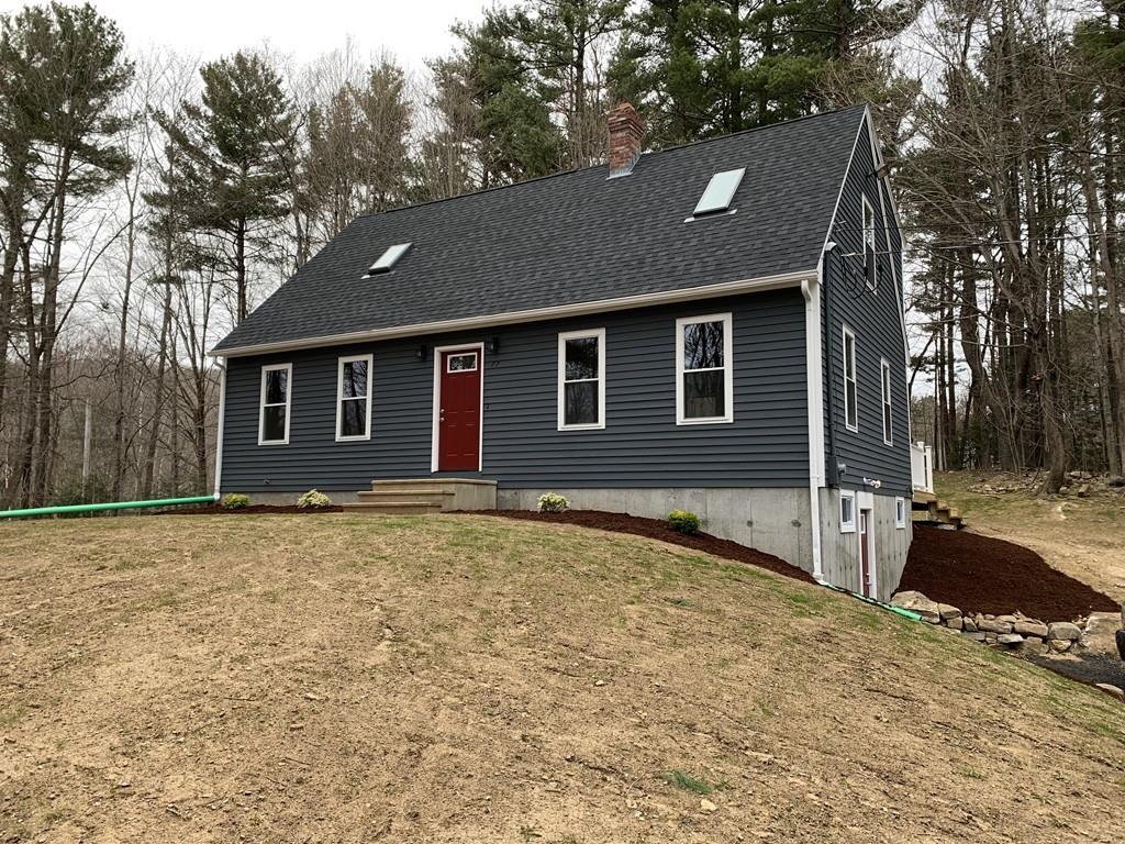 77 May Brook Road Holland, MA 01521 - Photo 2 of 23 a front view of a house with a yard and garage