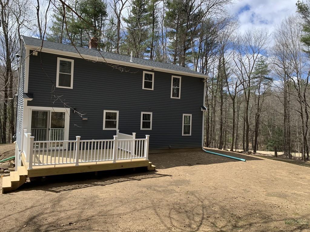 77 May Brook Road Holland, MA 01521 - Photo 5 of 23 a view of a deck with a fence and trees