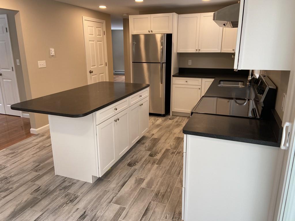 77 May Brook Road Holland, MA 01521 - Photo 7 of 23 a kitchen with stainless steel appliances a refrigerator and a stove
