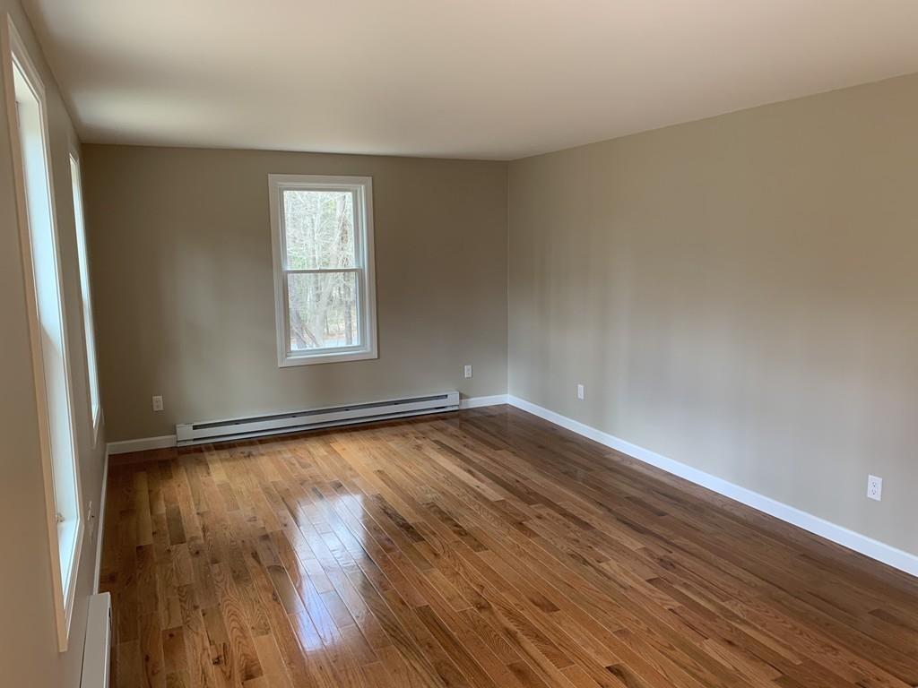 77 May Brook Road Holland, MA 01521 - Photo 10 of 23 wooden floor in an empty room with a window