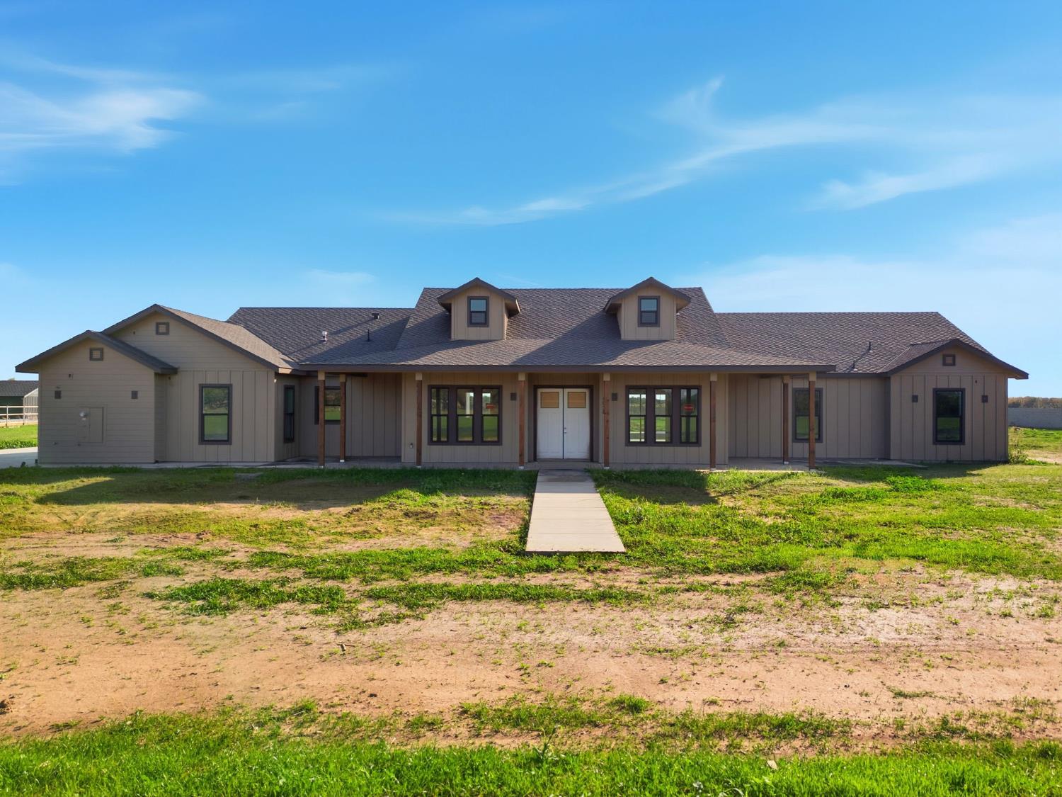 a front view of a house with a yard
